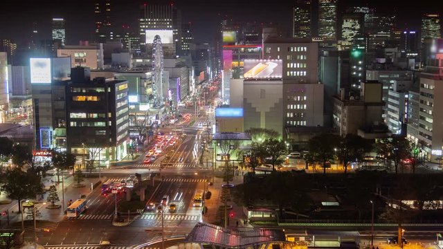 Timelapse night Nagoya city with main highway at rush hour among highrise buildings and skyscrapers at bright illumination