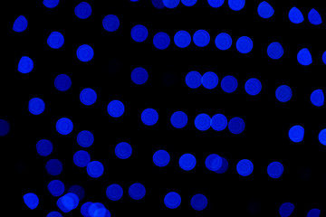 Defocused of blurred phantom blue bokeh circle light from lighting bulb in the dark night for abstract background texture patterns