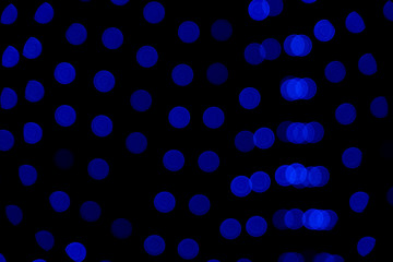 Defocused of blurred phantom blue bokeh circle light from lighting bulb in the dark night for abstract background texture patterns