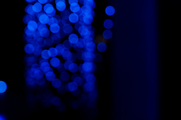 Defocused of blurred phantom blue bokeh circle light from lighting bulb in the dark night for abstract background texture patterns