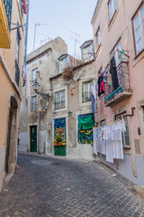 LISBON, PORTUGAL - OCTOBER 10, 2017: Narrow alley in Alfama neighborhood of Lisbon, Portugal