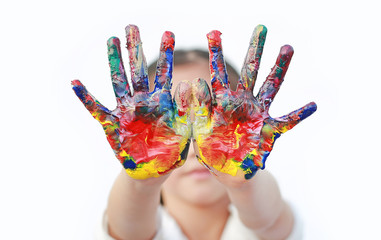 Close up kid hands painted in colorful paints isolated over white background.