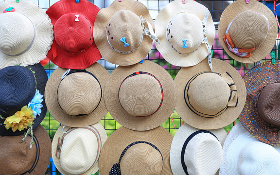 Many Of Hats Hang On Grille For Sale In Market.