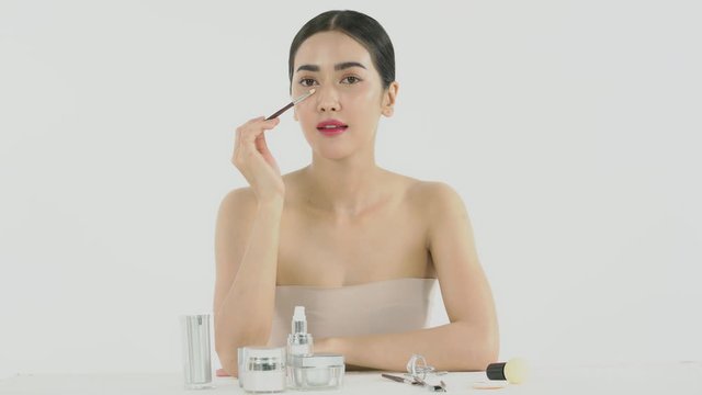 Beautiful woman face with nice applies make up by brush