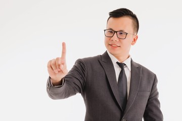 Young Asian businessman wearing glasses and gesture with hand pointing isolated on white background.Concept of  success creative startup business.