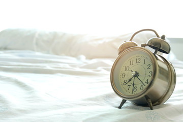 Morning of a new day, alarm clock on the beach sunlight in morning. Health and holiday concept.