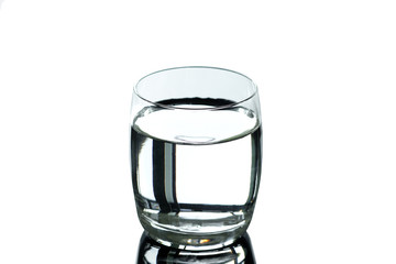 Drinking water and a glass of mineral water placed on the table on the White Blackground