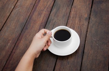 cup of coffee on wooden background