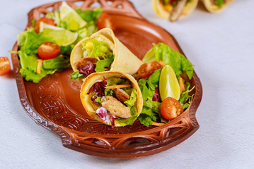Latin style food tortilla baked cones with meat and salad.