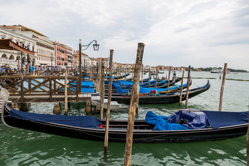 Fototapeta na wymiar Jetty with gondolas on the Venice promenade