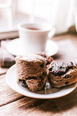 Sliced dried fruit chocolate scones with jam in the small saucer. 