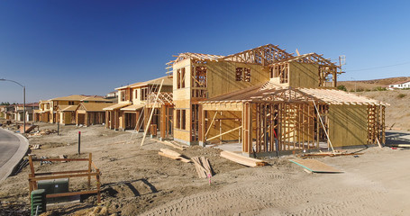 Fototapeta na wymiar New Homes Framing Being Built Construction Site