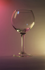 wine glass on a pink and yellow background