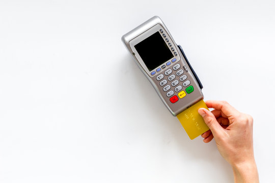 Payments in shops. Hand insert bank card in terminal on white background top-down copy space