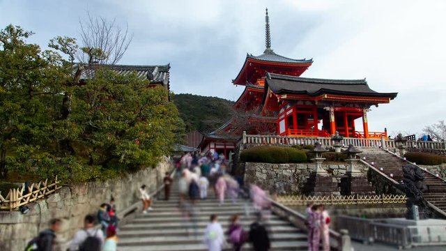 Timelapse Kyoto local people crowd on stairs at Buddhism religious symbol Kiyomizu-dera temple complex on sunny spring day