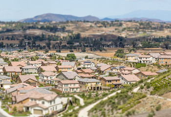Fototapeta na wymiar Aerial View of Populated Neigborhood Of Houses With Tilt-Shift Blur