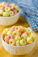 Cereal flakes in white bowl with copy space,Breakfast concept.Food with delicious fruity taste and fruity colours.It's made with maize,wheat,and barley