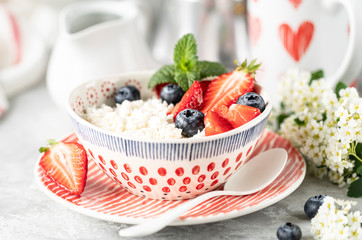 Cottage cheese with berries, jam, fresh strawberries and a cup of coffee with cream for breakfast. The recipe for the holiday Valentine's Day. close-up