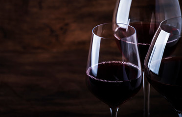 Wine glass. Selection of red wines on wine tasting. Dry, semi-dry, sweet red wine on old wooden...