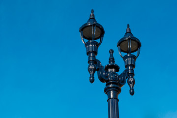Fototapeta na wymiar A vintage street lamp in an urban city.