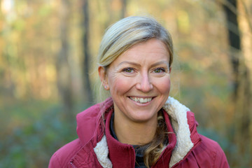 Adult woman in red jacket smiling at camera