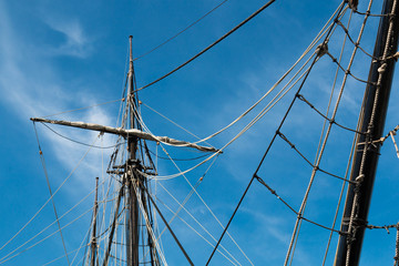 View from below of the mast and shrouds of a vintage tall ship. 