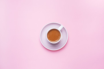 A Cup of coffee on a pink background with copy space. Top view. minimalism.