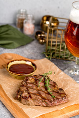 Grilled steak served with beer and sauce