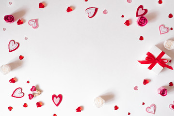 A gift frame with a red bow, beads, glass and felt hearts on a white background.