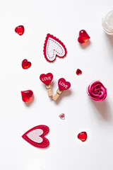 Romantic Valentine's day card: a variety of hearts, two clothespins with hearts and a rose