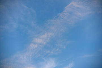 Naklejka na ściany i meble Fluffy clouds and blue sky on a clear day
