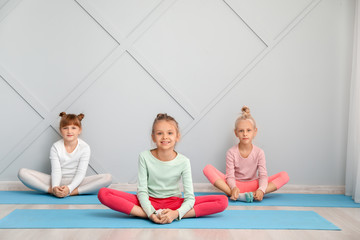 Obraz premium Little children practicing yoga in gym