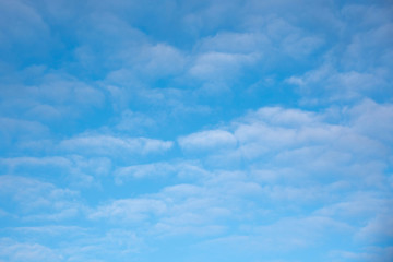Bright blue winter sky with white clouds.