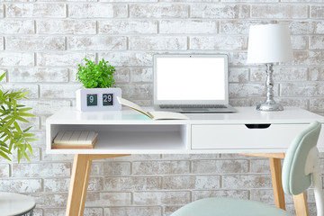 Stylish comfortable workplace with laptop in modern room