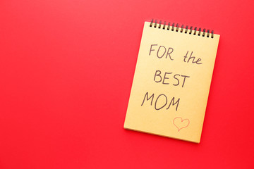 Notebook with text FOR BEST MOM on color background