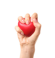 Female hand squeezing stress ball on white background