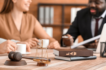 Scales of justice and gavel  on table of lawyer in office