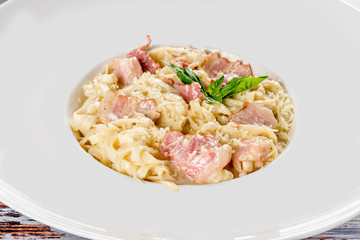 Carbonara pasta in a white plate shot close-up