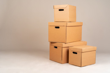 Pile of brown moxing boxes on grey background