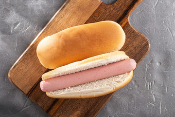  Hot dogs on a wooden board. Hot dogs served on a stone table. Free space for text