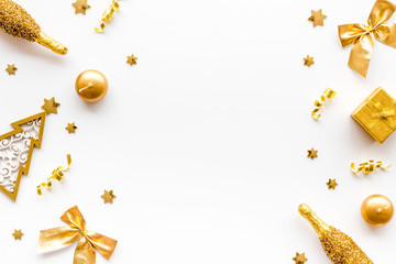 New Year symbols - tree, champagne, decorations - on white background top-down frame copy space