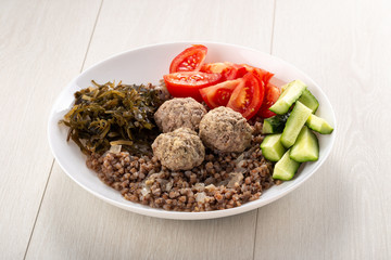 Dinner bowl with buckwheat, chicken meatball. buckwheat with meatballs and vegetables