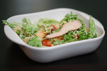 Caesar salad with chicken in a square dish