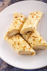 Homemade pancakes with cream cheese and berry jam on a plate, selective focus