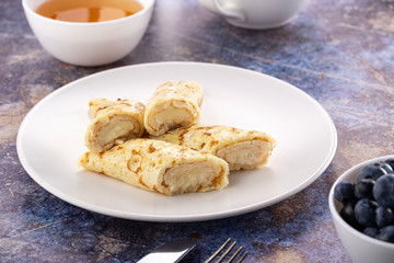 Homemade pancakes with cream cheese and berry jam on a plate, selective focus