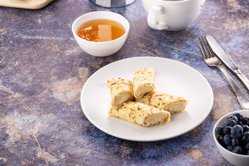 Homemade pancakes with cream cheese and berry jam on a plate, selective focus