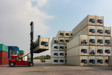 Forklift reach stacker is lifting the reefer container in the container depot as for business and...