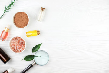 Homemade spa cosmetic set with salt and oil on white wooden background. Copy space. Flat lay style.