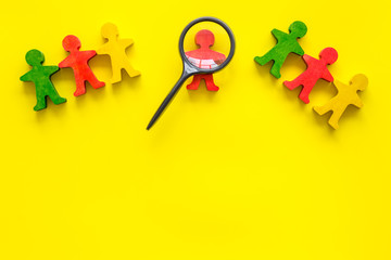 Tolerance concept. Social research. eople cutouts under magnifier on yellow background top-down...