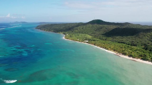 High aerial view of colorful tropical caribbean island, over ocean reef, Roatan